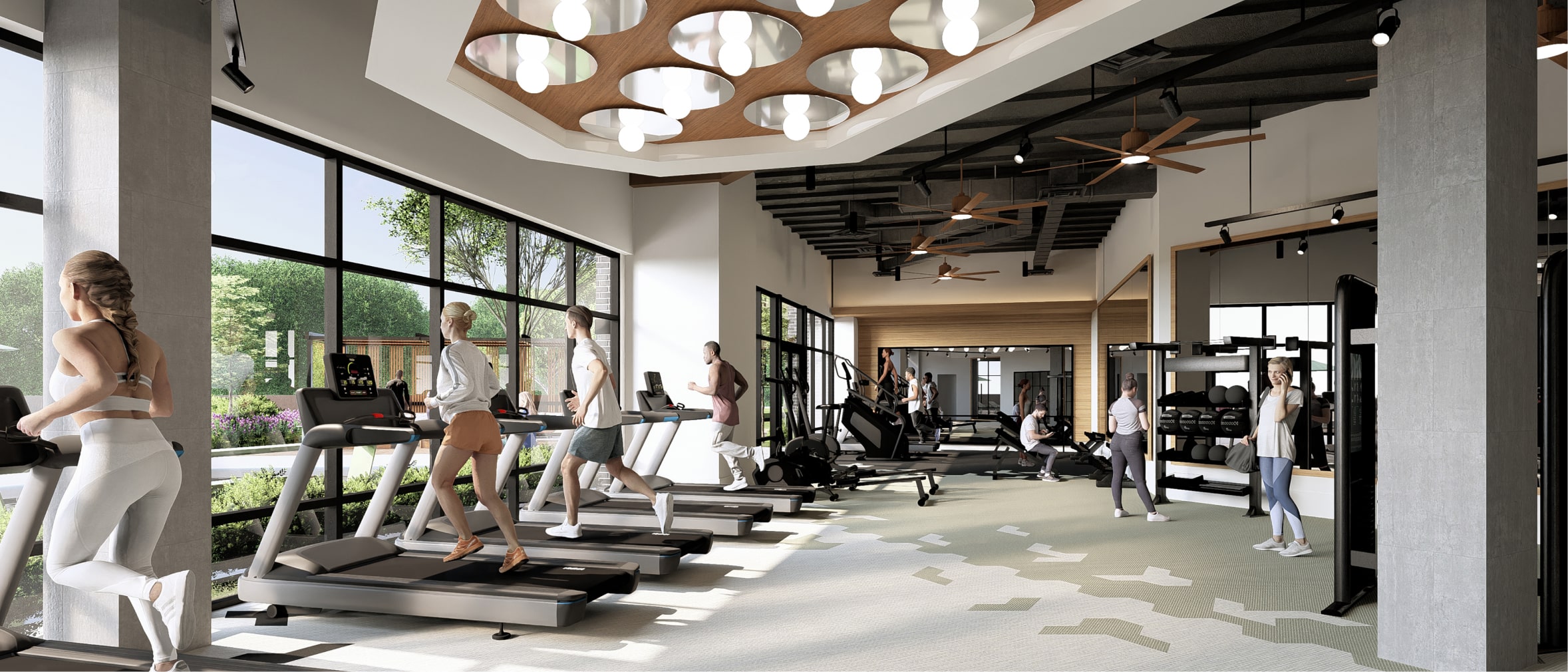 A fully equipped fitness center with mirror and glass walls and bright lighting